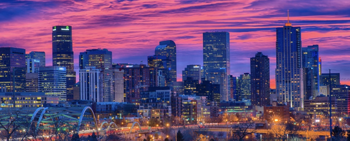 Denver skyline at sunset with purple and pink skies
